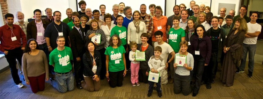 OLPC community group wearing summit T-shirts.